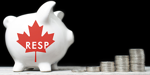 Photo of a piggy bank and some coins depicting RESPs (Registered Education Saving Plans)